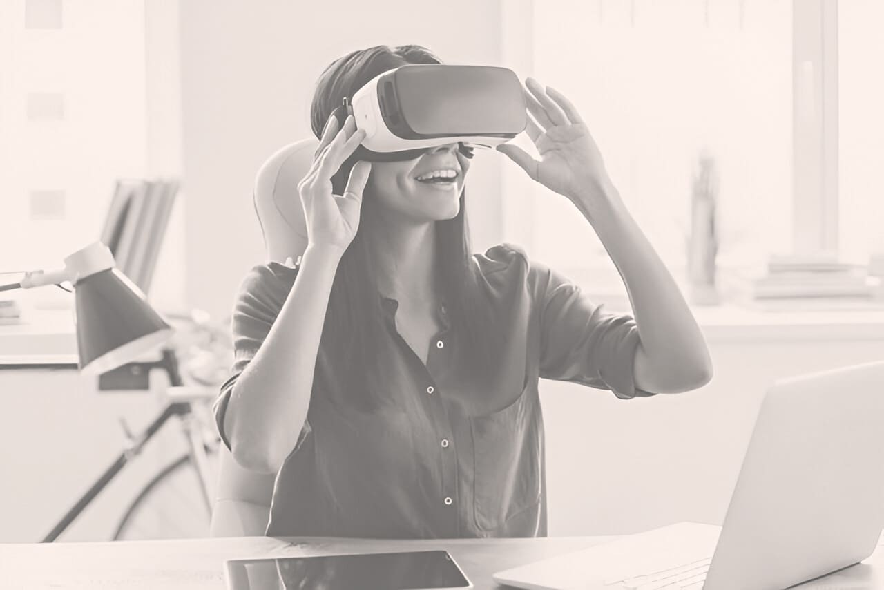 A woman wearing a vr headset while sitting at a table.